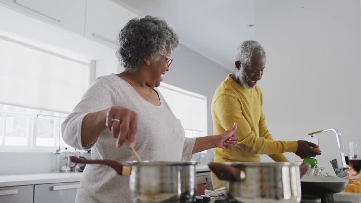A senior African american couple cooking at home. Social distancing in quarantine