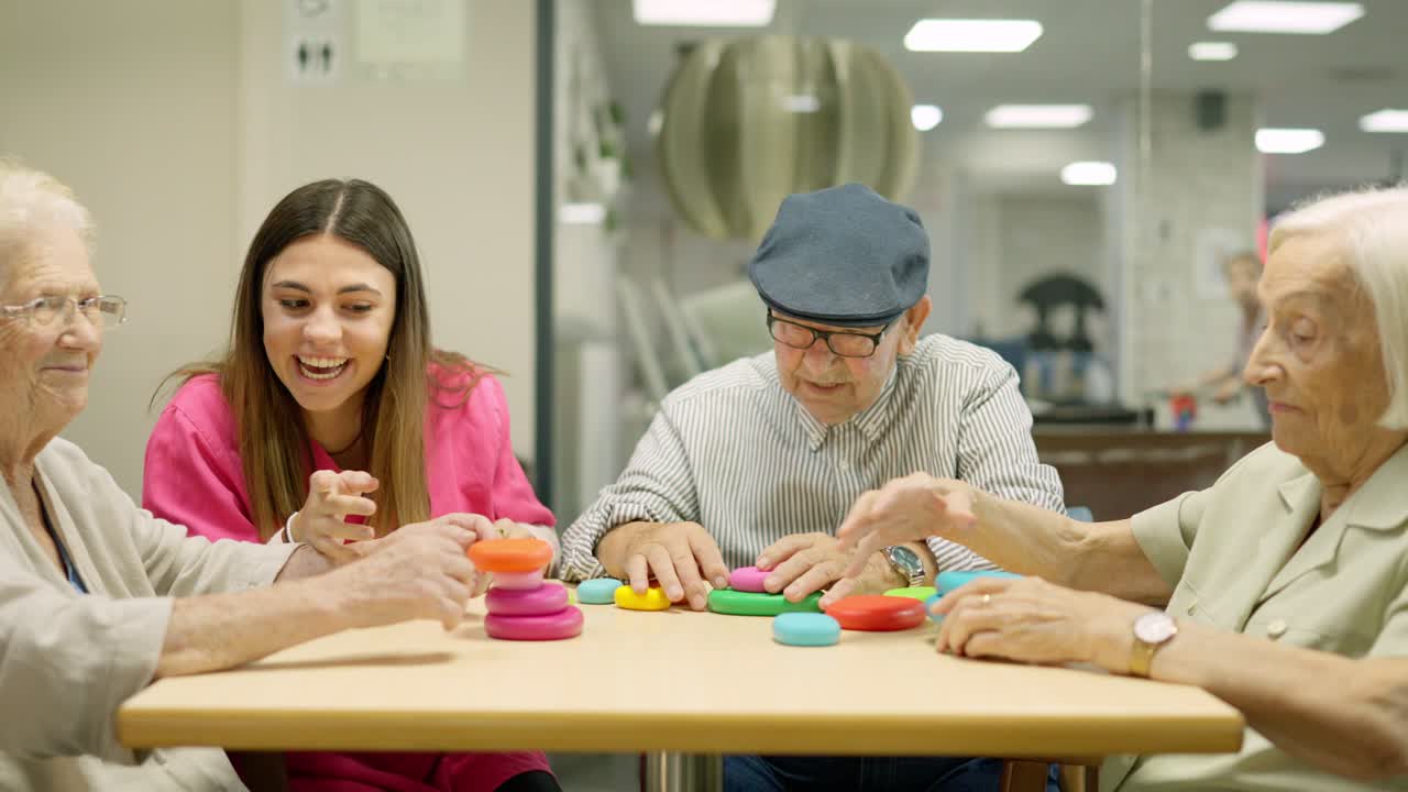 Elderly people playing a game with a caregiver