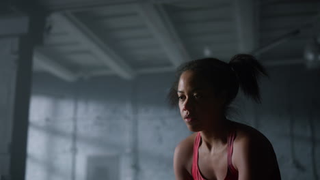 strong sportswoman battling ropes in gym. woman using sports equipment