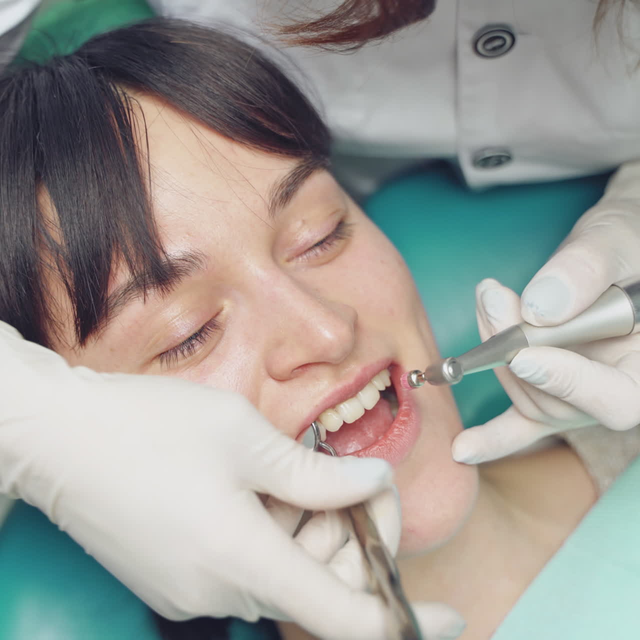 Dentist at work in the office. Woman dentist working at her patients teeth
