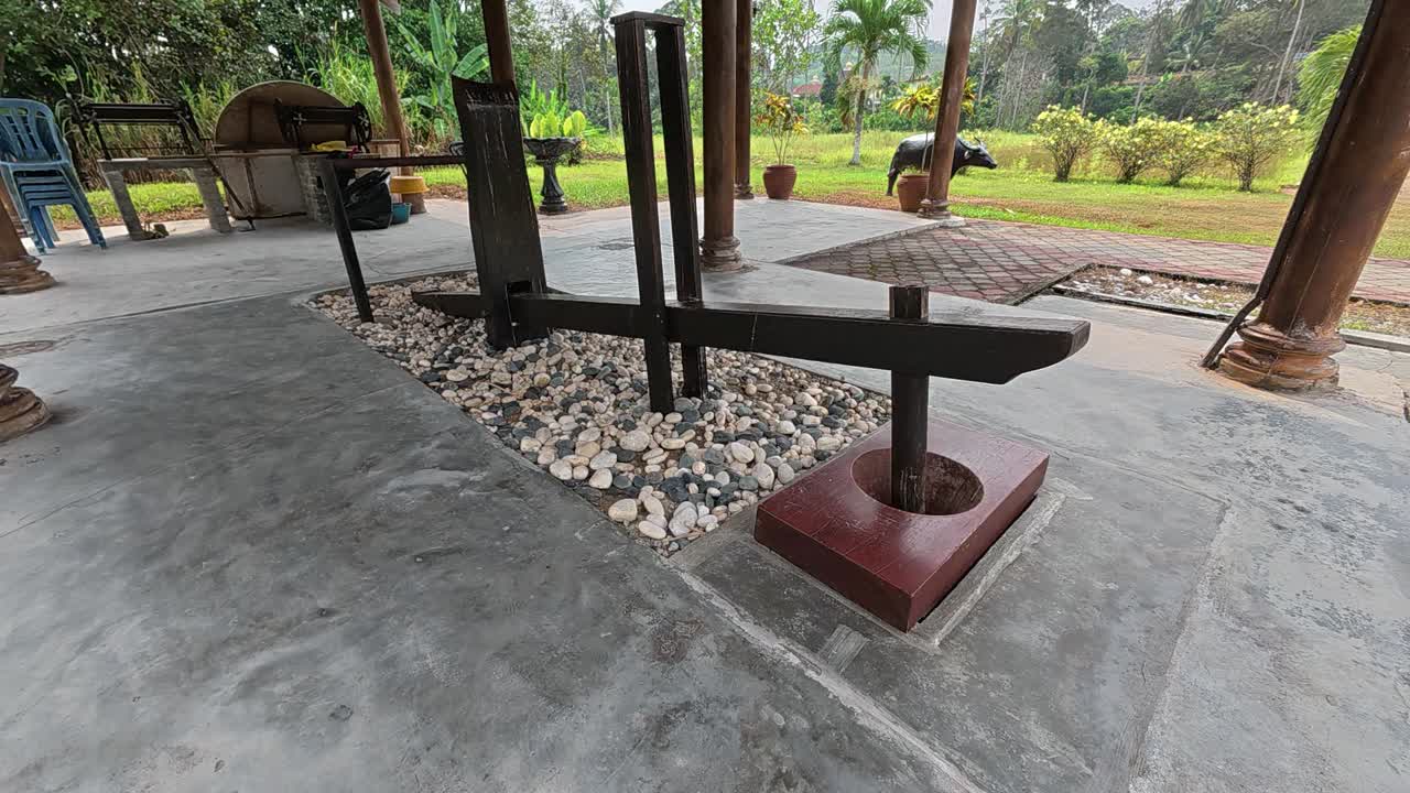 Traditional foot-operated mortar and pestle (lesung kaki) used for processing food. A rhythmic, old-world method