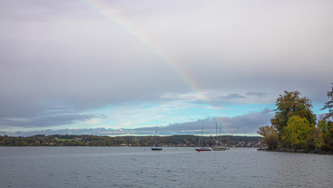 rainbow over lake attersee and sailboats, time lapse view