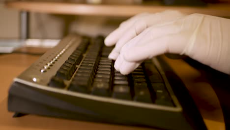 Man protecting hands against Covid-19 while using keyboard