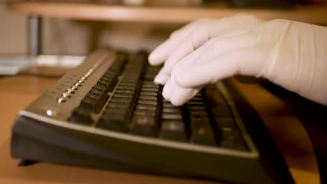 man protecting hands against covid-19 while using keyboard