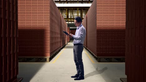 warehouse worker inspecting brick inventory