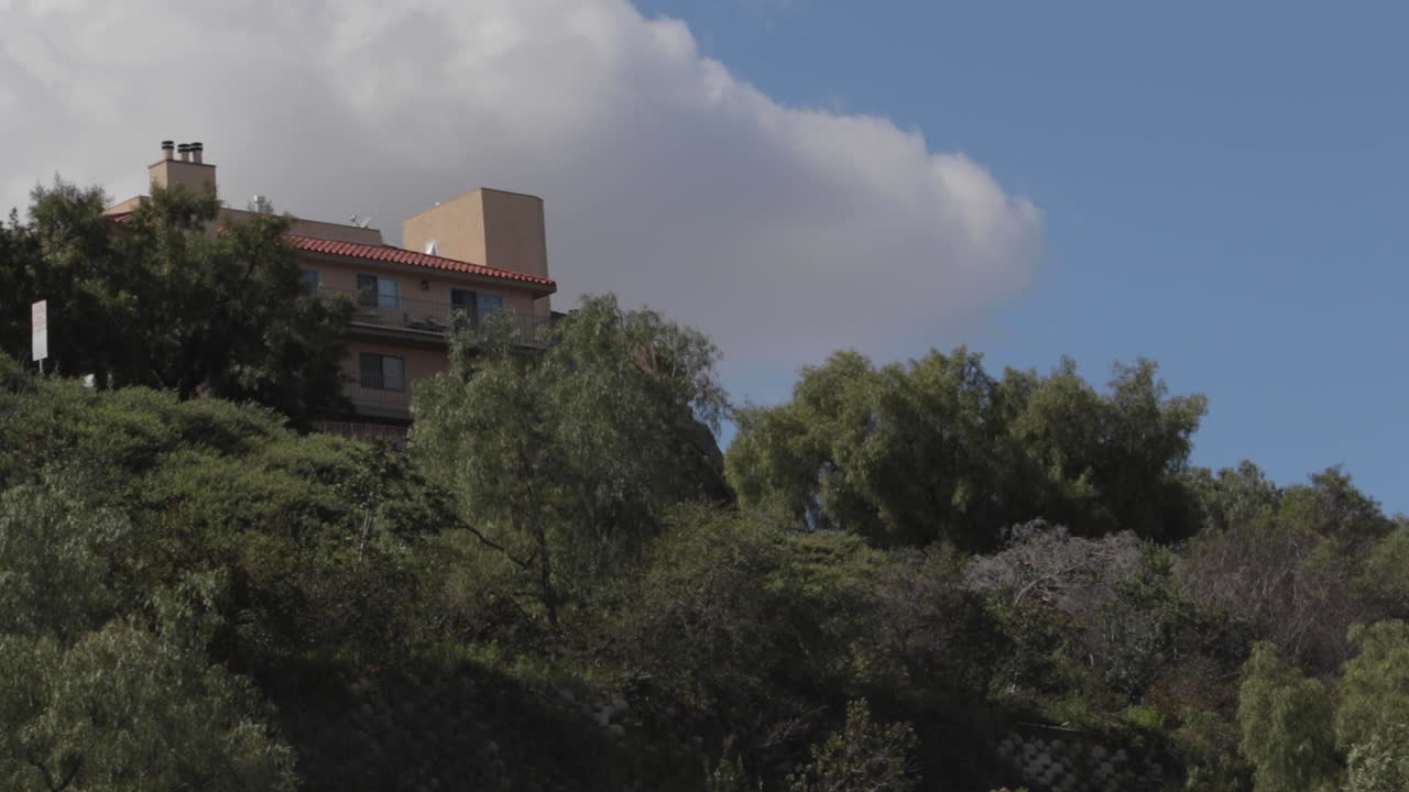 구름과 비행기가 있는 언덕 위에 건물