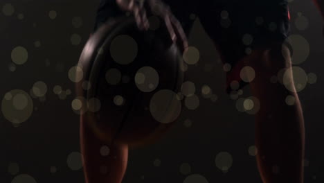 animation of african ameerican basketball player with ball and spots of light on black background