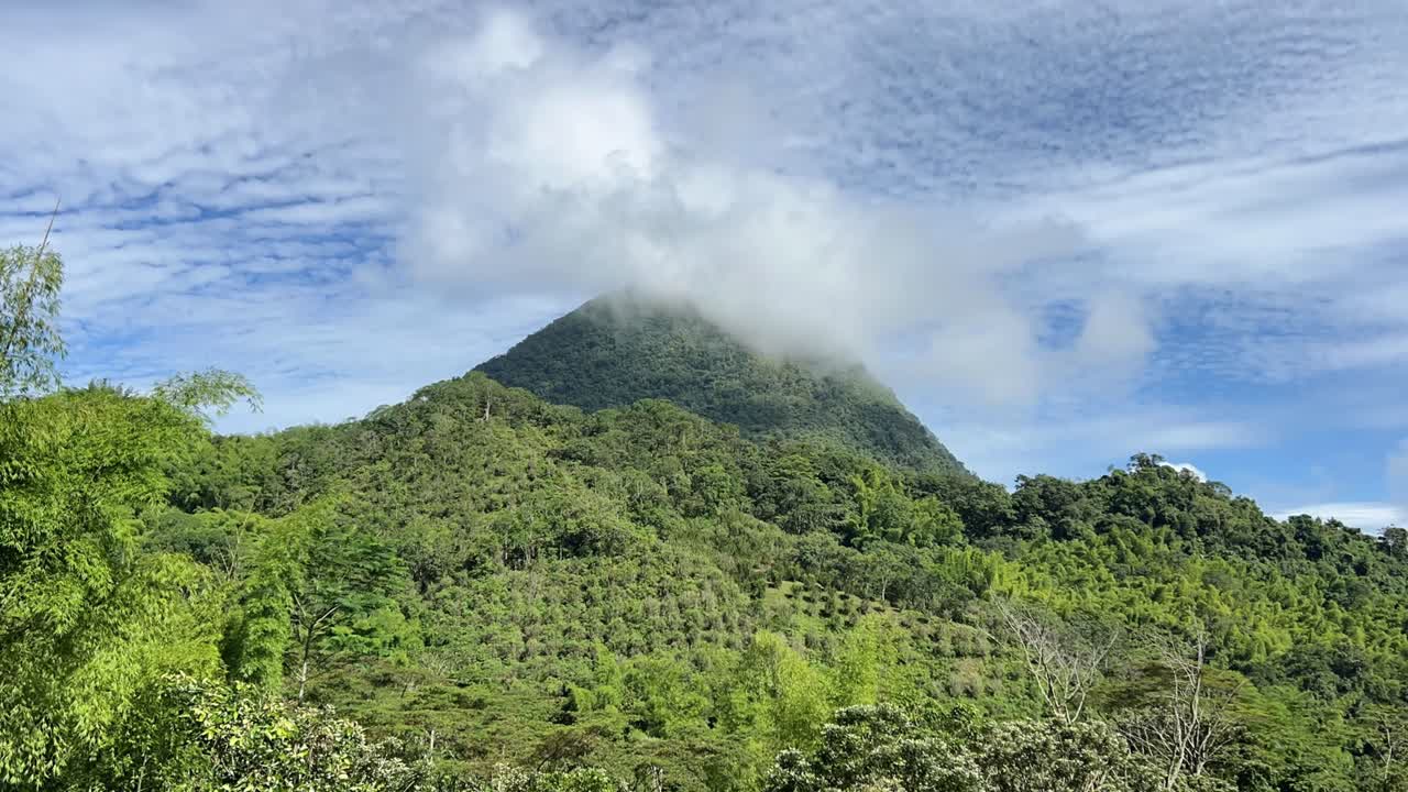 Clouds moving around the peak of Cerro Tusa, the pyramid-shaped mountain near Venecia in the Antioquia region of Colombia