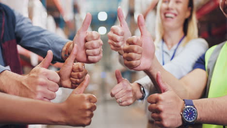 team gives thumbs up in warehouse