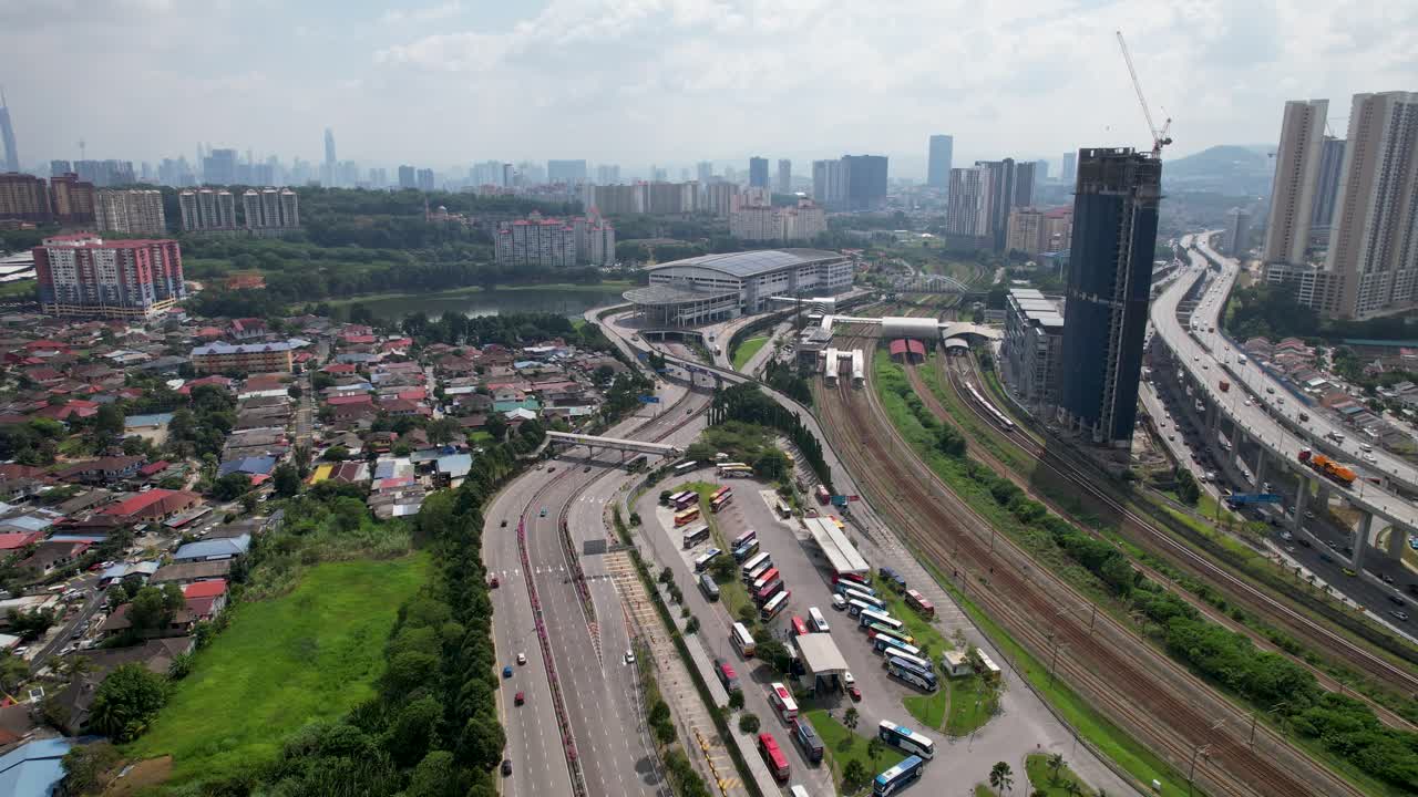 Aerial view of cityscape with highway and train station