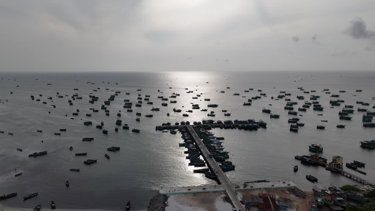 An aerial video of Rameshwaram a breathtaking view of this serene island town during sunrise. picturesque coastline dotted with colorful fishing boats anchored on the shore