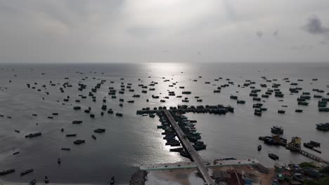 an aerial video of rameshwaram a breathtaking view of this serene island town during sunrise. picturesque coastline dotted with colorful fishing boats anchored on the shore