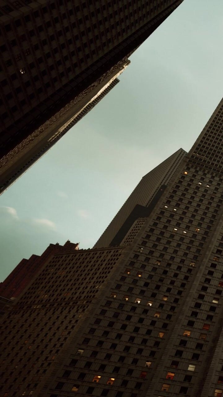 Skyscrapers tower above streets during dusk in a busy city center