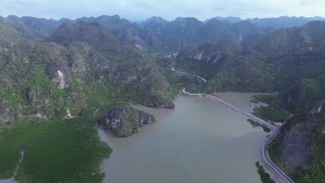 elevating camera angle over lush jungle and limestone formations in northern vietnam