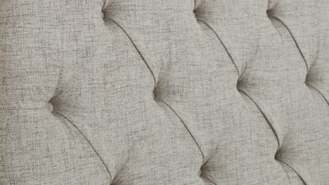 camera moves over upholstered headboard texture in bedroom
