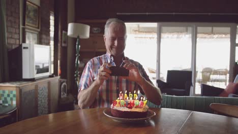 senior man with a birthday cake at home