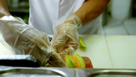 Male-chef-cutting-avocado-fruit-in-kitchen-4k