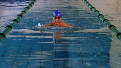 Fit-swimmer-doing-the-breast-stroke-in-swimming-pool