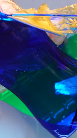 vertical, plastic bags and bottles in water, microplastic pollution, close up