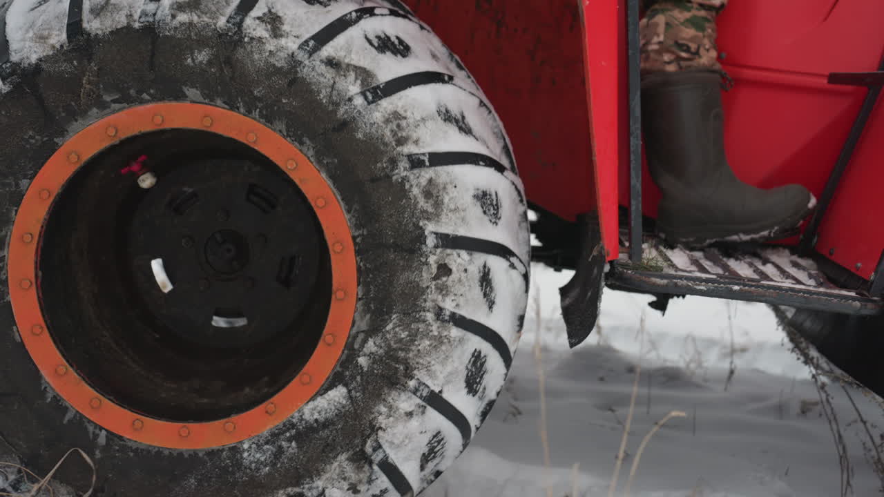 Close view of muddy tire. Detailed image of snowcovered vehicle tire. Zoomedin shot revealing snow and mud on tire surface. Detailed closeup capturing vehicle tire embedded with snow and mud
