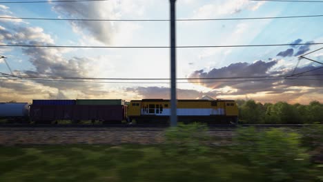 a freight train hauls shipping containers through the landscape, sunset and blue sky