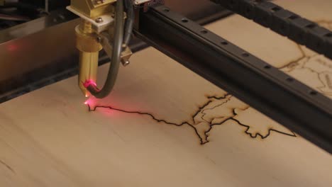 cnc laser cutting machine cuts wooden plank and plywood