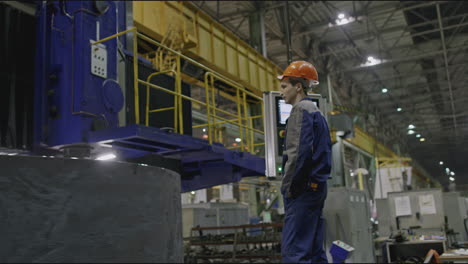 factory worker observing machinery