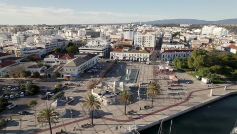 square with fountain in portimao seafront promenade, portugal