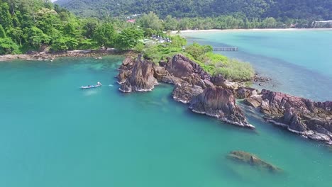 idyllic koh chang island aerial push in view towards turquoise coastal ocean bay resort buildings thailand