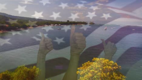 animation of flag of usa blowing over okay hands on beach landscape