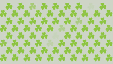 digital animation of multiple clover leaves flickering against grey background