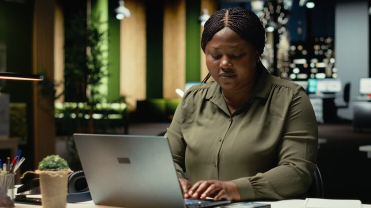 Female advisor engaged in reading emails and documenting updates