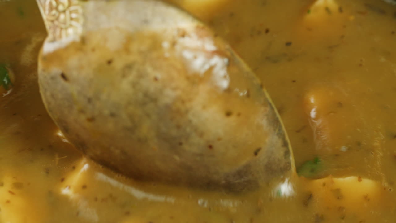 Cooking traditional Indian meal Palak Panir with spinach and cheese close up. Palak paneer is an Indian dish, consisting of paneer in a thick paste made from pureed spinach, Palak paneer is prepared by first boiling and pureeing spinach.