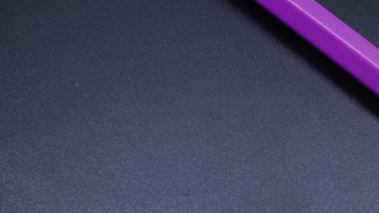 Purple colored pencil crayon rotating macro shot, zoom close up video