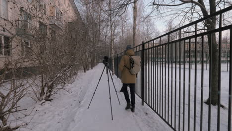 man photographer taking shots outdoor in winter