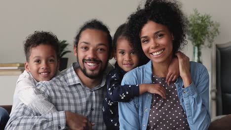 portrait of happy smiling african family with preschool children