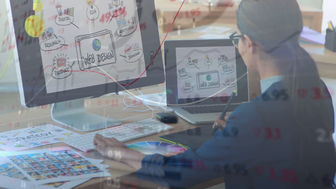 Designer holding stylus, refining web UI while analytics and red trend floating on screens