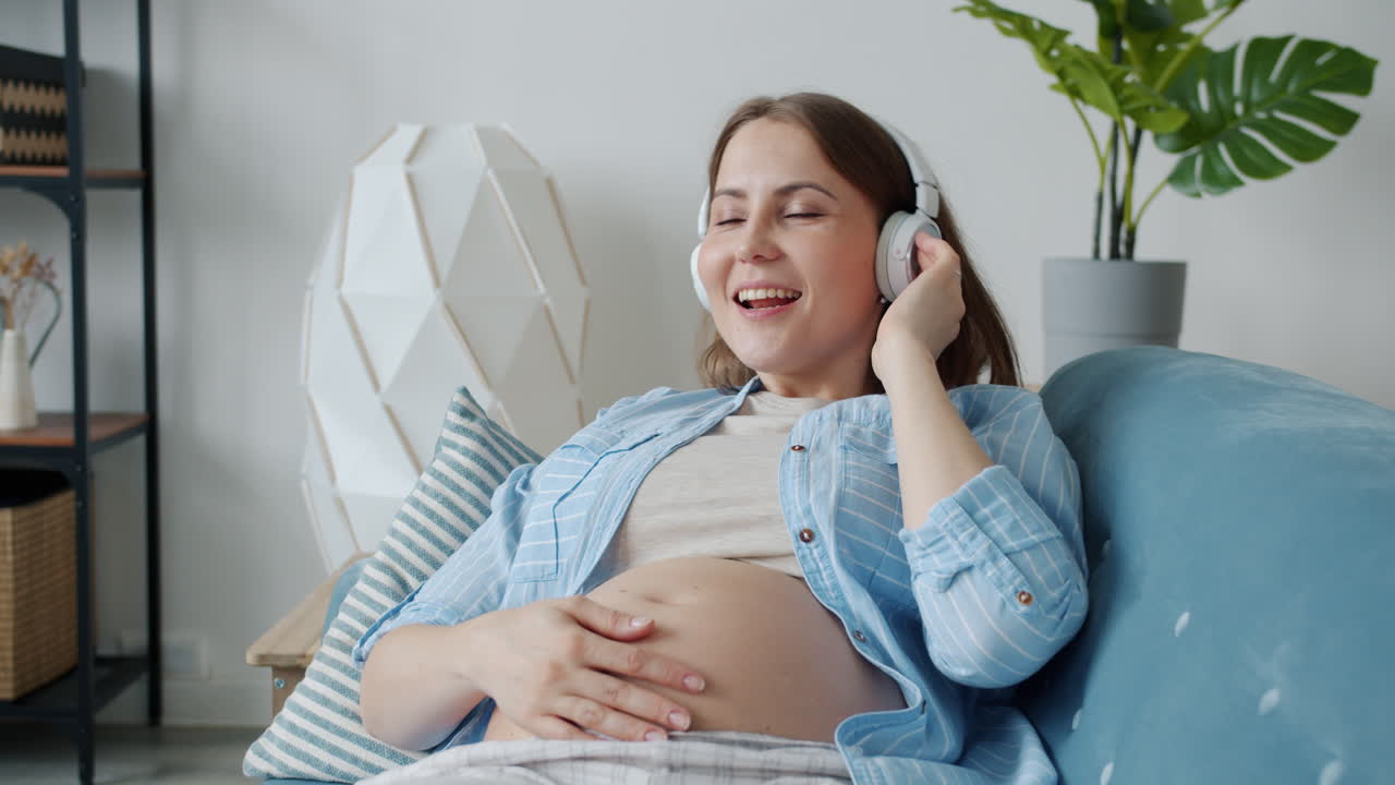 Pregnant Woman Listening to Music on Couch