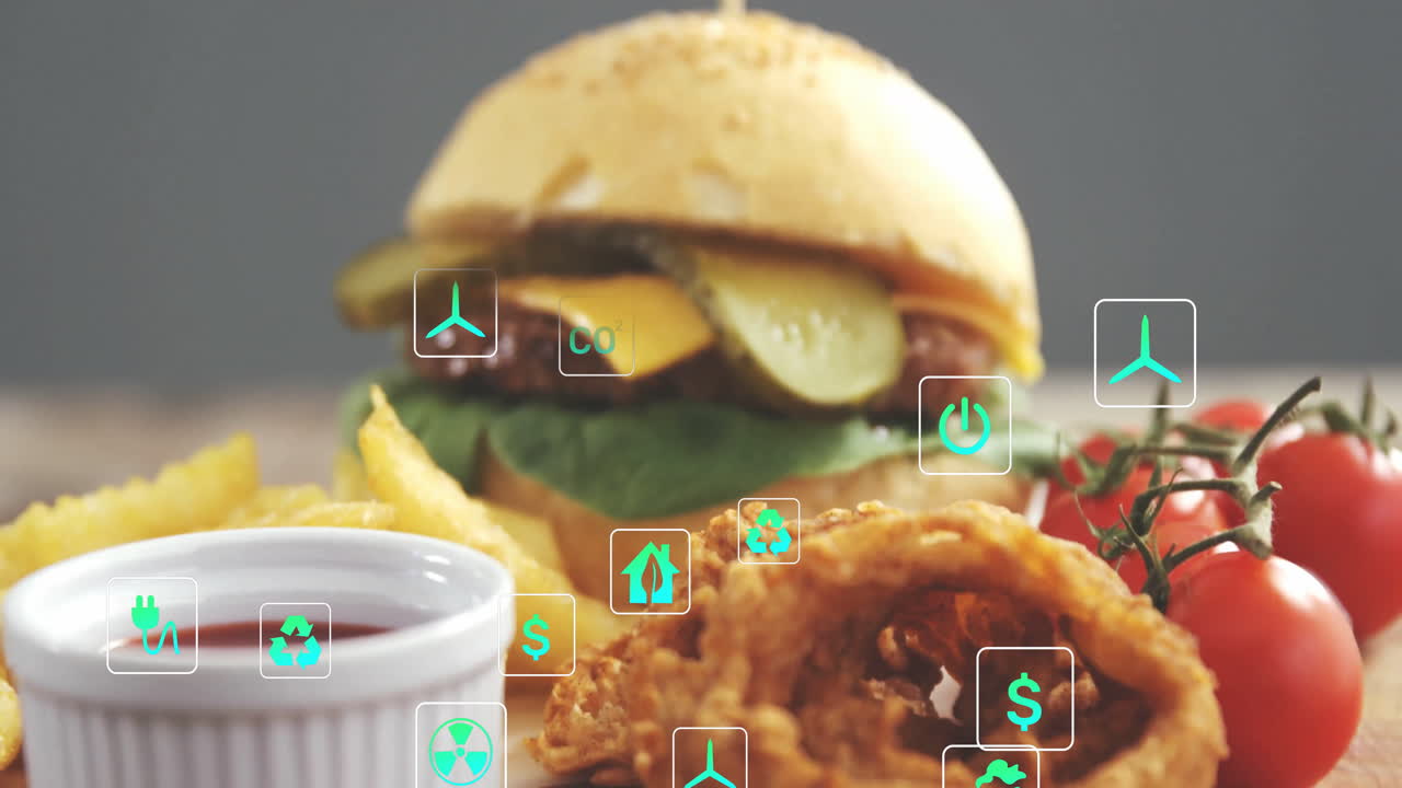 Burger with fries and onion rings overlaid with eco-friendly icons animation