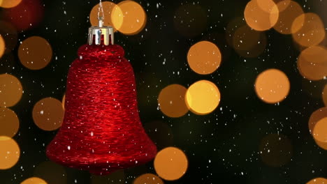 video composition with falling snow over blurry video of christmas tree lights and red bell