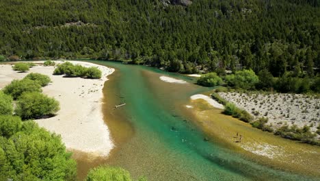 people fly fishing in lake cholila, patagonia, argentina, aerial forward flyover wide shot