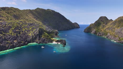tranquil top view of star beach, with some boats around in tapiutan island, philippines