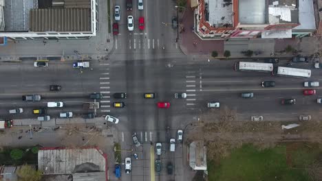 bustling city intersection with diverse vehicles and pedestrians, overcast buenos aires, aerial view