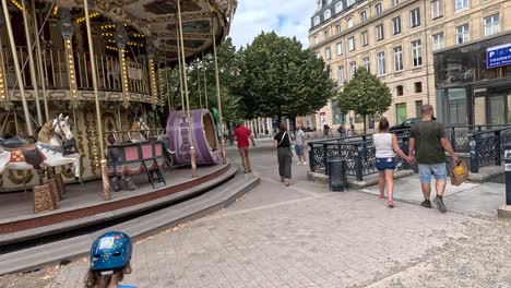 people walking near a stationary carousel