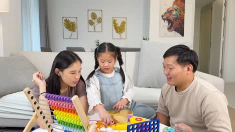 a family enjoys quality time using colorful educational toys in a cozy living room setting with natural lighting