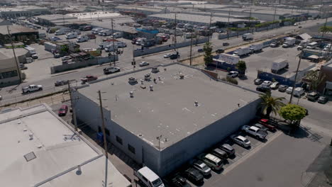 From-an-elevated-perspective,-the-downtown-area-of-Los-Angeles-appears-to-be-a-vibrant-community-with-many-vehicles-navigating-the-streets-on-a-sunny-and-clear-day