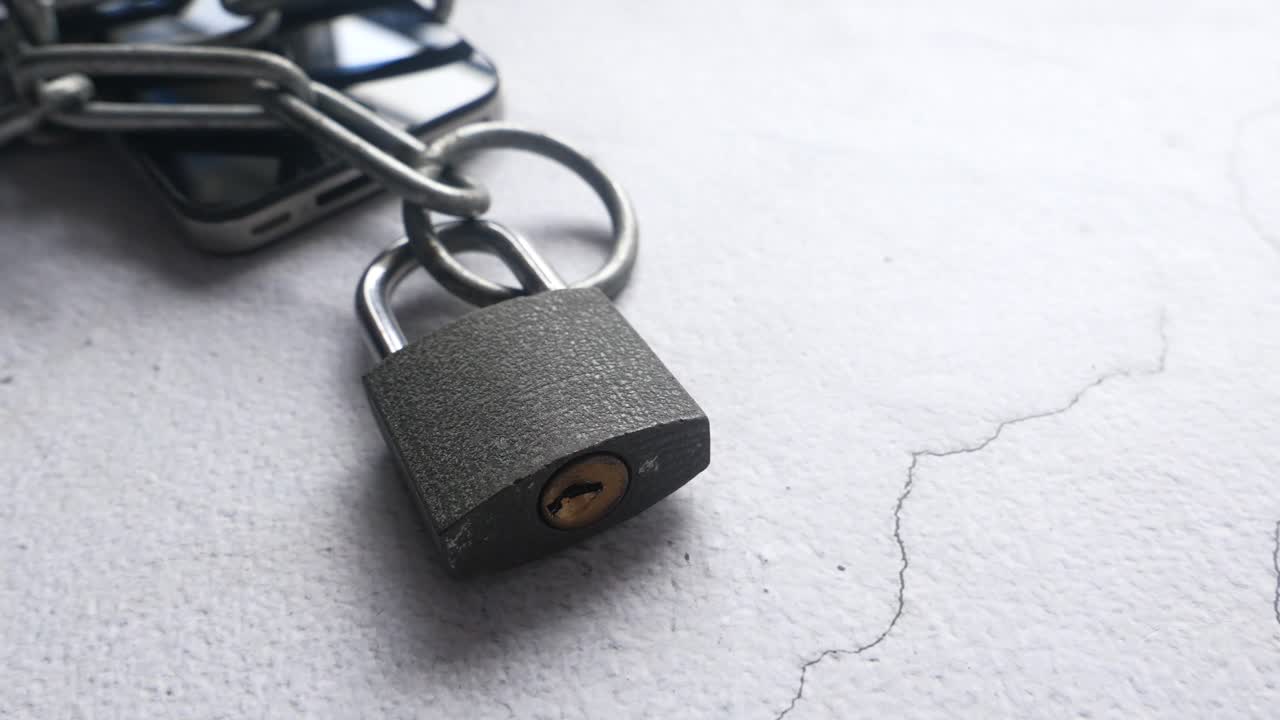 teléfono inteligente cerrado con cadena y candado