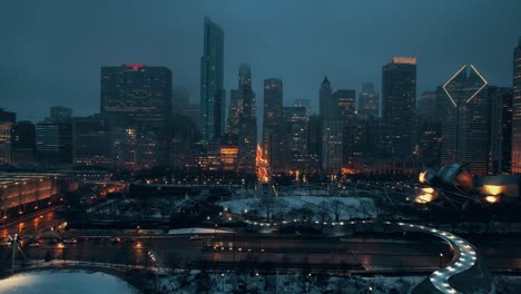 night epic drone shot of chicago showcasing downtown covered with beautiful lighting