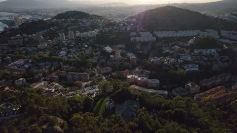 Vista-Aérea-De-La-Luz-Del-Sol-En-ángulo-Bajo-Sobre-La-Ciudad-Mediterránea-De-Málaga,-España