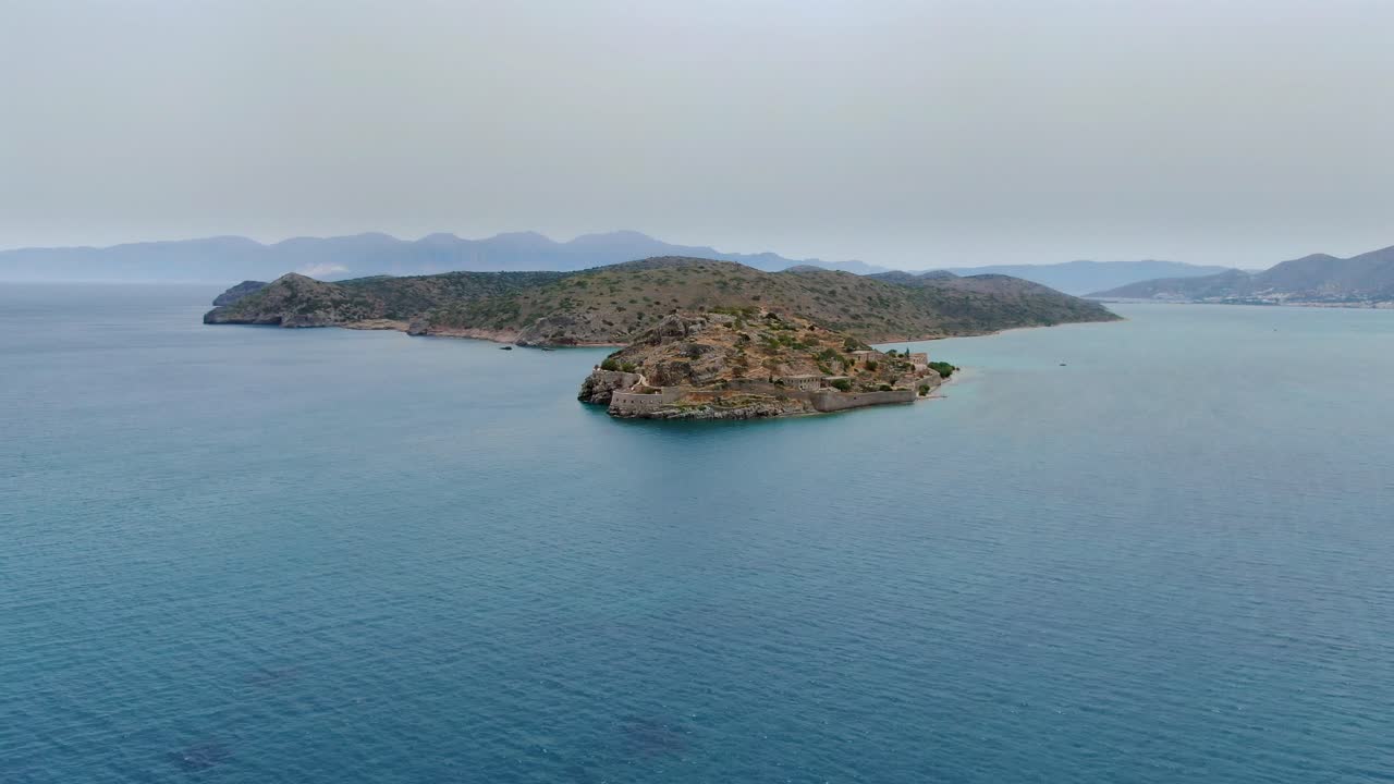 Spectacular establishing view of Spinalonga island, Crete, Greece, aerial approach